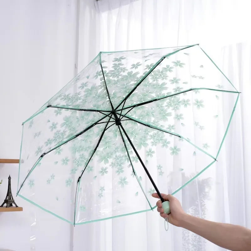 This transparent cherry blossom umbrella features a stylish and unique three-fold design presenting a fresh and simple aesthetic