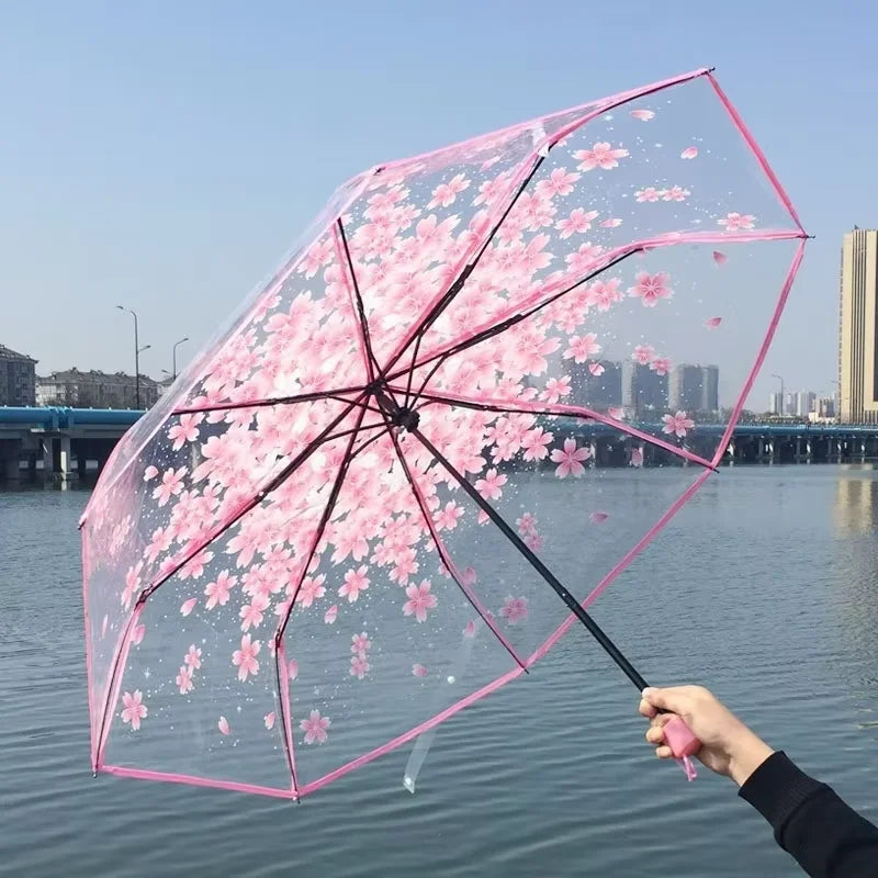 This transparent cherry blossom umbrella features a stylish and unique three-fold design presenting a fresh and simple aesthetic