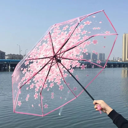 This transparent cherry blossom umbrella features a stylish and unique three-fold design presenting a fresh and simple aesthetic