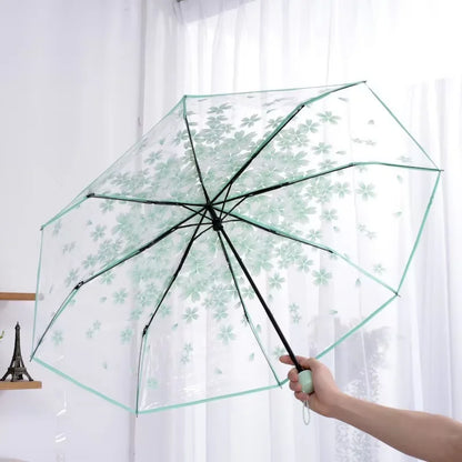 This transparent cherry blossom umbrella features a stylish and unique three-fold design presenting a fresh and simple aesthetic