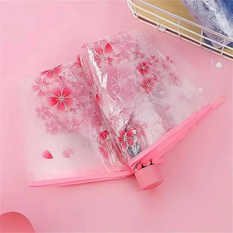 This transparent cherry blossom umbrella features a stylish and unique three-fold design presenting a fresh and simple aesthetic