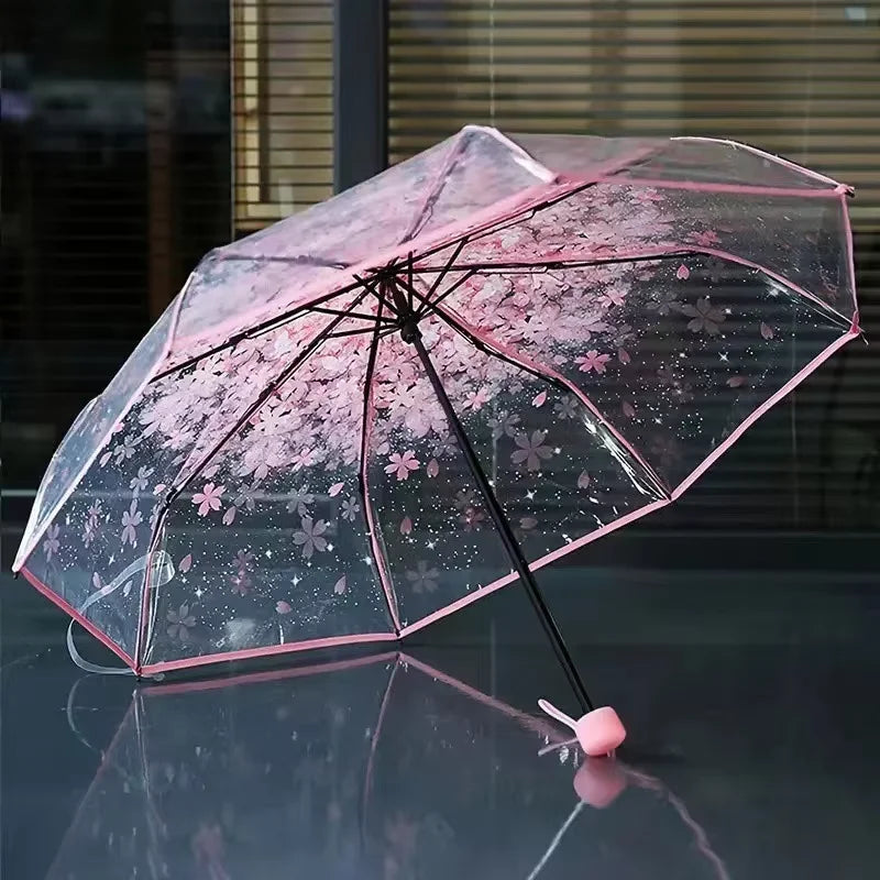 This transparent cherry blossom umbrella features a stylish and unique three-fold design presenting a fresh and simple aesthetic