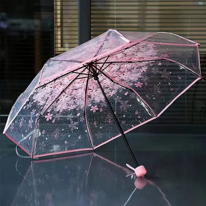 This transparent cherry blossom umbrella features a stylish and unique three-fold design presenting a fresh and simple aesthetic