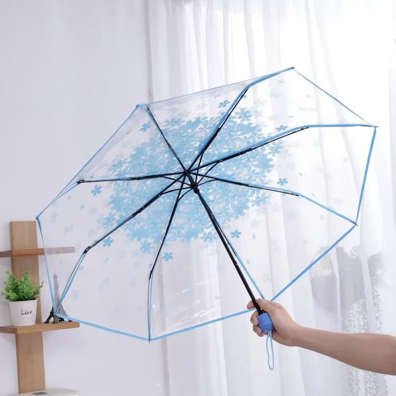 This transparent cherry blossom umbrella features a stylish and unique three-fold design presenting a fresh and simple aesthetic