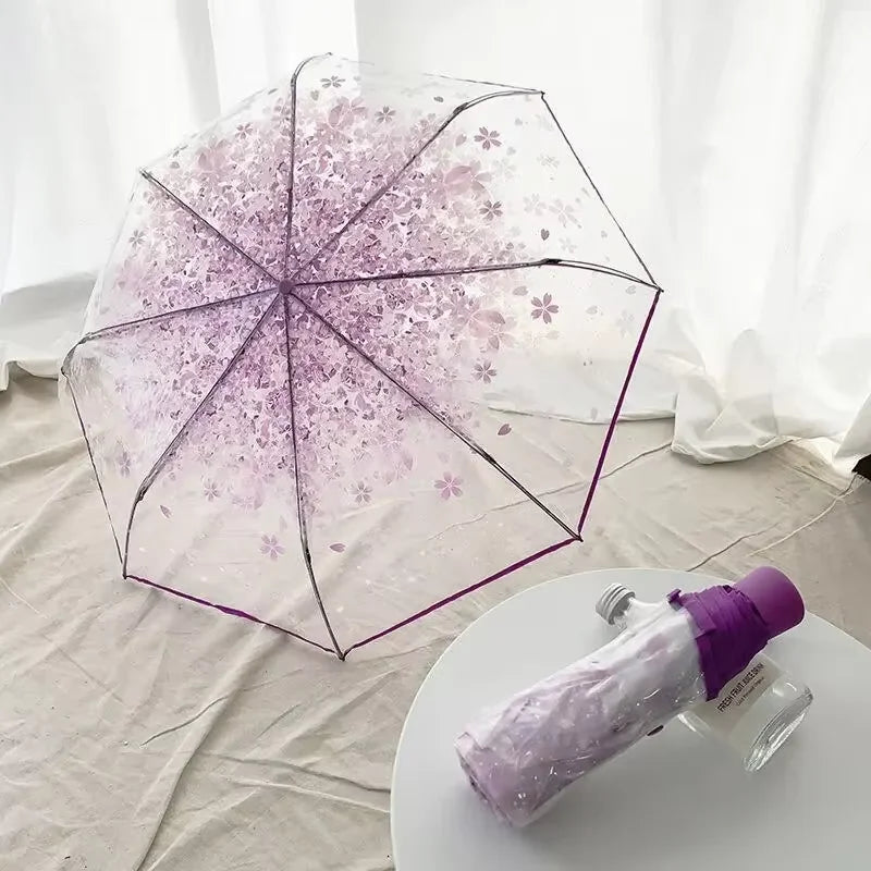This transparent cherry blossom umbrella features a stylish and unique three-fold design presenting a fresh and simple aesthetic