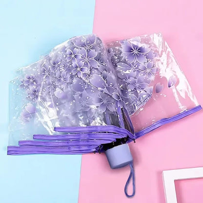 This transparent cherry blossom umbrella features a stylish and unique three-fold design presenting a fresh and simple aesthetic