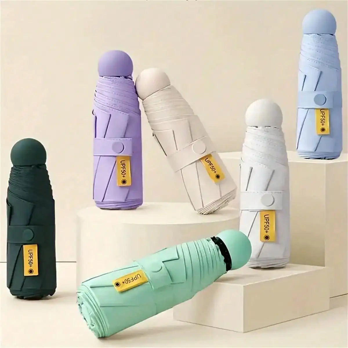 Compact black mini capsule umbrella - portable, foldable, manually open, with sun protection coating, durable design with