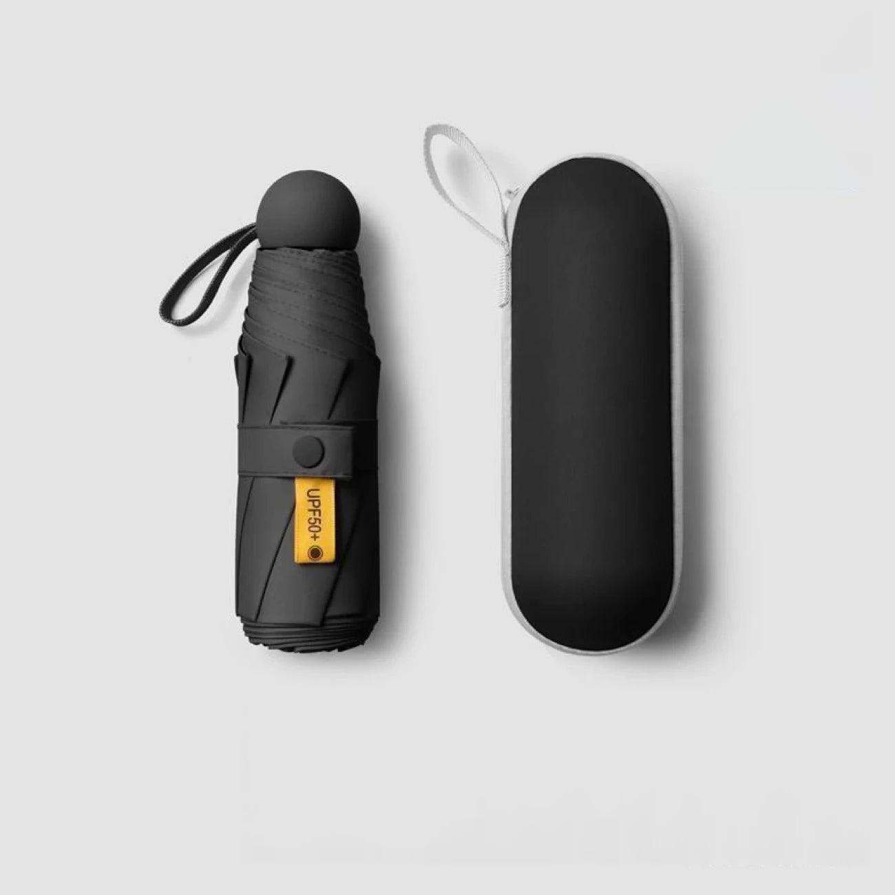 Compact black mini capsule umbrella - portable, foldable, manually open, with sun protection coating, durable design with